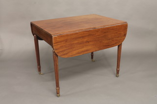 A 19th Century mahogany Pembroke table fitted a drawer and  raised on turned and reeded supports 36"