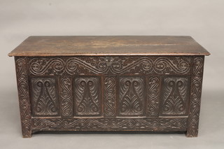 An 18th Century carved oak coffer of panelled construction with hinged lid 55"  ILLUSTRATED