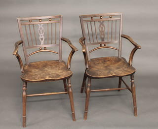 A pair of 19th Century elm and fruitwood stick and rail back  carver chairs with solid seats, turned supports and H framed  stretchers
