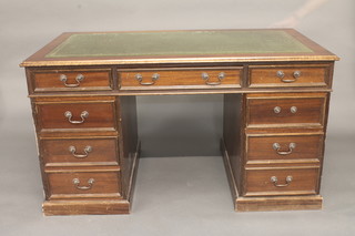 A Georgian style mahogany kneehole pedestal desk with green inset leather writing surface above 1 long and 8 short drawers  54"