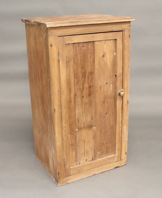 A pine cupboard with shelved interior enclosed by a panelled door 24"