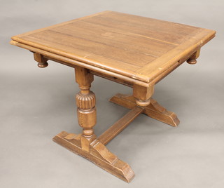 An oak refectory style drawleaf dining table, raised on bulbous turned supports with H framed stretcher 36"