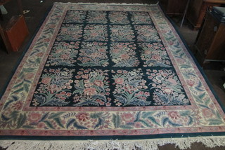 A green ground and floral patterned Chinese carpet 142" x 108"