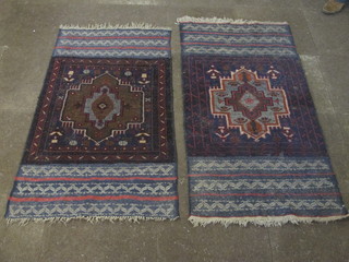 A pair of Bokhara style rugs with stylised octagons to the centre, 58" x 30", 1 holed and worn,