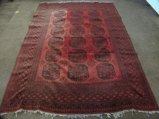 A red ground Afghan rug with 18 octagons to the centre 113" x  78"