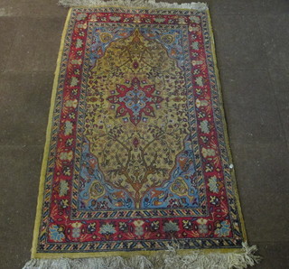 A yellow ground rug with oval medallion to the centre, within multi-row borders 63" x 36"