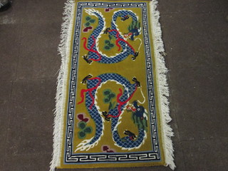 A yellow ground Chinese rug decorated dragons 51" x 24"