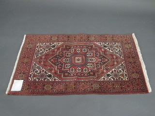 A fine quality Persian rug with central medallion within multi-row borders 48" x 32"