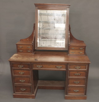 A Victorian mahogany dressing table with mirror, fitted 4 long glove drawers, the base fitted 1 long drawer above 8 short  drawers 54"