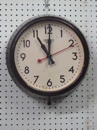 A Smiths electric wall clock contained in a brown Bakelite case