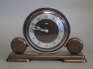 An Art Deco mantel clock by Metamec contained in an oak case  with silvered chapter ring