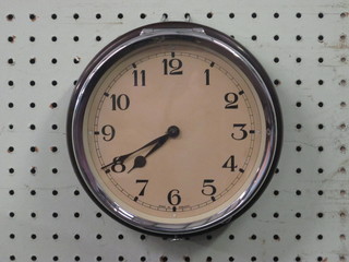 A wall clock contained in a brown Bakelite case with painted dial