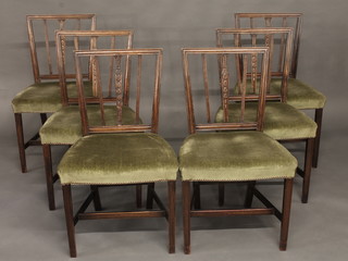 A set of 6 Georgian style mahogany stick and rail back dining  chairs with upholstered seats, raised on square tapering supports