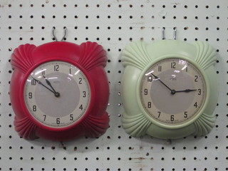 A Metamec electric wall clock with silvered dial contained in a  green case and 1 other contained in a red case