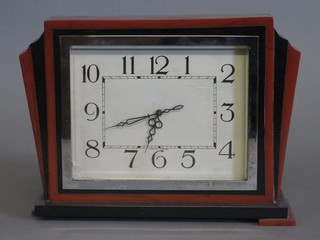 An Art Deco mantel clock with square painted dial and Arabic  numerals contained in a black and brown plastic case 10"