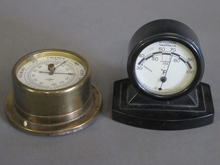 A barometer with paper dial by S & B contained in a gilt metal  case 4" together with a thermometer contained in a black Bakelite  case