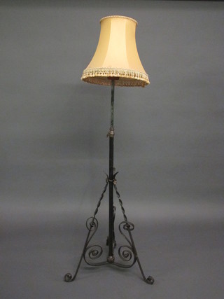 A wrought iron adjustable oil lamp stand