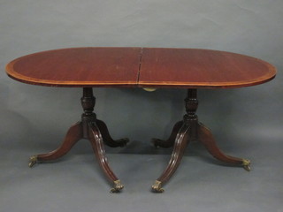 A Georgian style mahogany D end dining table, the top cross-banded with figured walnut, raised on pillar and tripod  supports with 1 extra leaf