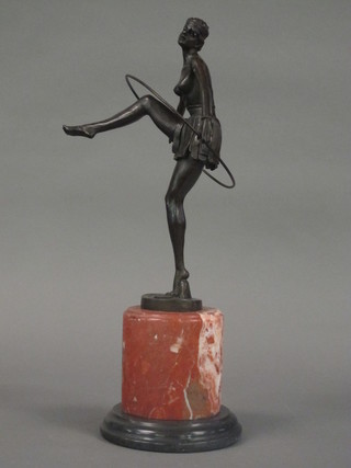 An Art Deco style bronze figure of a dancing girl with hoop,  raised on a circular marble base
