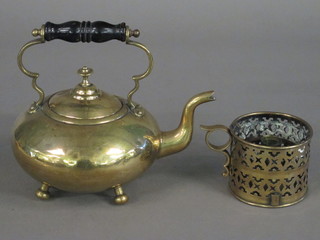 A circular brass kettle and a pierced brass chamber stick