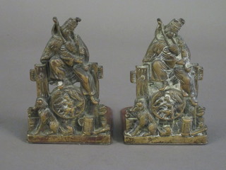 A pair of brass bookends decorated scenes from Aesop's Fables