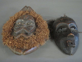 2 carved wooden African masks