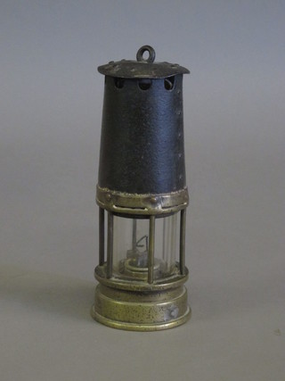 An iron and brass miner's safety lamp