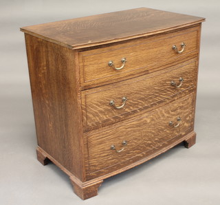 A Georgian style oak bow front chest of 3 long drawers with  brass swan neck drop handles, raised on bracket feet 36"
