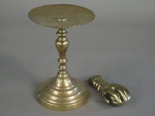 A brass pedestal 10" and a gilt metal door knocker in the form of a hand clasping a ball