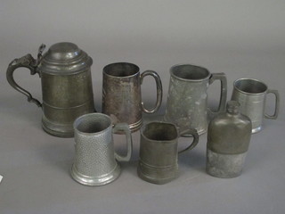 A pewter lidded tankard with glass base, 4 other pewter tankards,  a pewter hip flask and a silver plated tankard