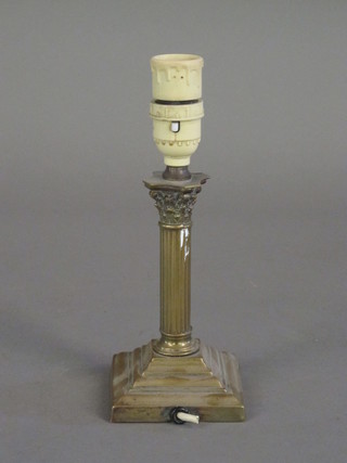 A reeded brass table lamp with Corinthian capital raised on a stepped base 7"  ILLUSTRATED