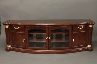 An Oriental hardwood bow front sideboard fitted a cupboard  enclosed by glazed panelled doors flanked by a pair of drawers  with cupboard beneath 80"