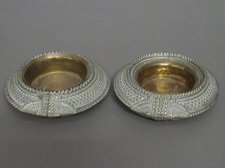 A pair of ashtrays formed from shackle bracelets 6"