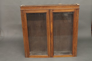 An Edwardian walnut bookcase/display cabinet, the shelved interior enclosed by glazed panelled doors 44"