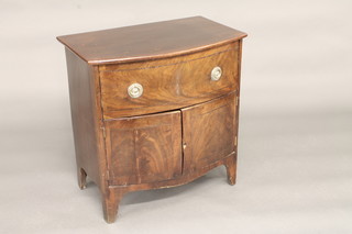 A 19th Century mahogany bow front commode fitted a drawer  above a double cupboard, raised on bracket feet 26"
