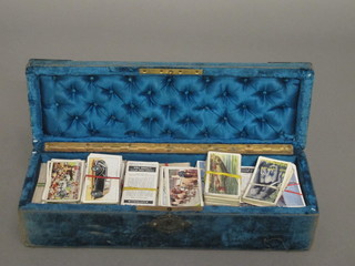 A plush box containing various cigarette cards