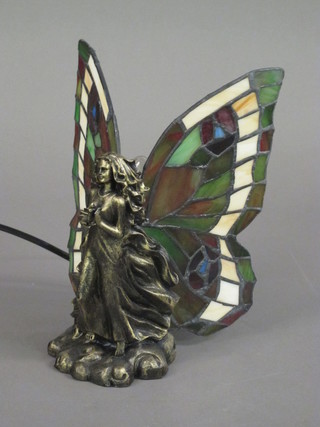 A bronzed table lamp with stained glass shade in the form of a standing lady