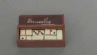 A miniature set of dominoes contained in a wooden case 2"
