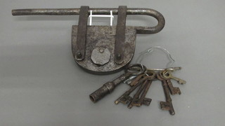A large polished steel padlock 5" and a collection of antique keys