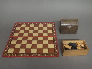 A wooden chess set together with a cardboard board