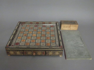 A wooden chess set, a Moorish chessboard and a cardboard  chessboard