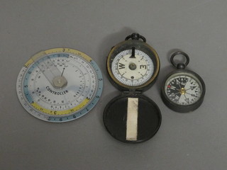 A circular West German calculator and 2 compasses