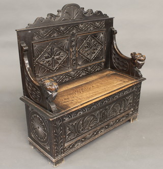 A Victorian carved oak settle with raised back 40"