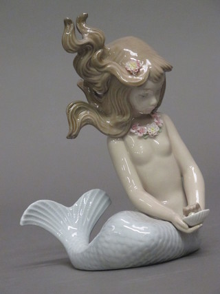 A Lladro figure of a seated Mermaid 5"
