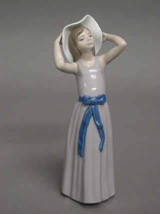 A Lladro figure of a standing bonnetted girl, base marked 5011  10"