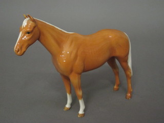 A Beswick figure of a standing Palomino horse 8", ear f,