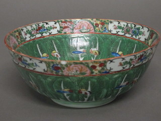 A circular Oriental famille vert bowl with panel decoration 9"