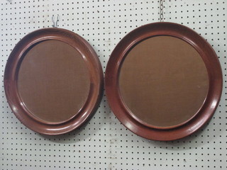 A pair of circular plate wall mirrors contained in turned oak  frames 15"