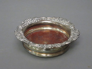 A circular silver plated wine bottle coaster