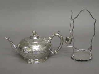 A circular engraved silver plated teapot with hinged lid and a silver plated picket stand